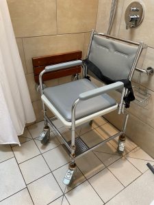 Wheeled shower chair in shower